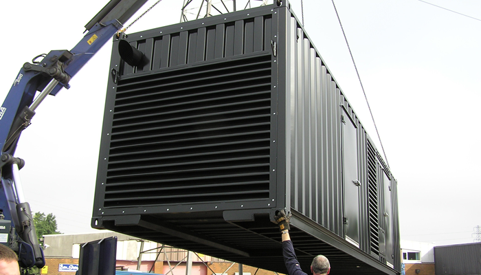 Halliwell ISO Container being loaded onto crane for site installation